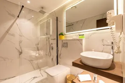 a bathroom with a sink and a toilet and a shower at Luxurious Apartment next to Burj Khalifa and Dubai Mall in Dubai