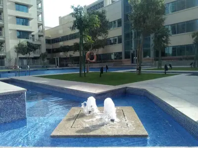 a fountain with two white birds in a swimming pool at Luxurious Apartment next to Burj Khalifa and Dubai Mall in Dubai