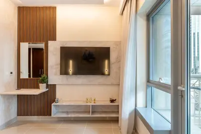 a bathroom with a sink and a tv on the wall at Luxurious Apartment next to Burj Khalifa and Dubai Mall in Dubai