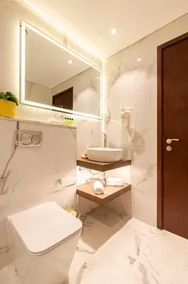 a white bathroom with a sink and a toilet at Luxurious Apartment next to Burj Khalifa and Dubai Mall in Dubai