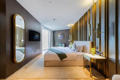 a bedroom with a large bed and a mirror at Superluxury Apartment in FIVE Palm, Pool & Beach Access in Dubai