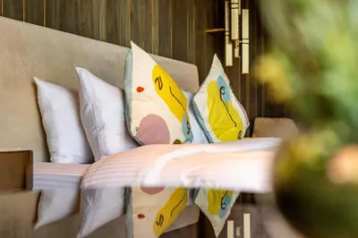 a bed with pillows with hello kitty pillows on it at Superluxury Apartment in FIVE Palm, Pool & Beach Access in Dubai