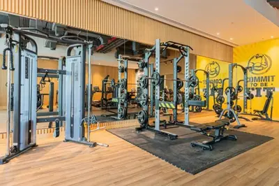 a gym with several tread machines in a room at 1 BR Rooftop Infinity Pool & Padel court in Dubai