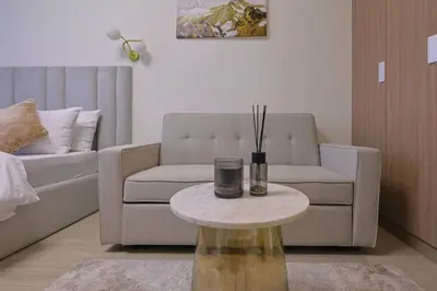a living room with a couch and a coffee table at Brand New Studio Near Downtown Dubai in Dubai