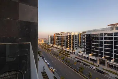 a view of a city with buildings and a highway at Brand New Studio Near Downtown Dubai in Dubai