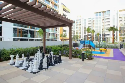 a giant chessboard in a park with a playground at Brand New Studio Near Downtown Dubai in Dubai