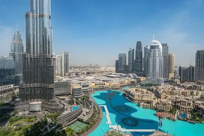 a view of a city with a river and buildings at Full Burj Khalifa & Fountain View All Rooms in Dubai