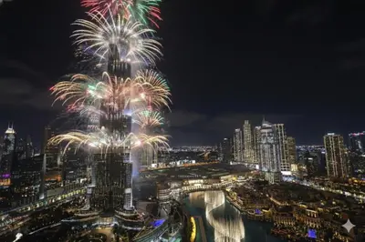 a firework display at the dubai skyline at night at Full Burj Khalifa & Fountain View All Rooms in Dubai