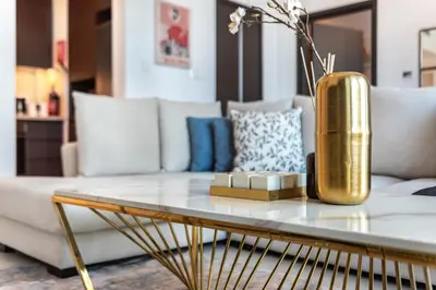 a living room with a gold vase on a coffee table at Classy Downtown Bliss with Dubai Mall Access in Dubai