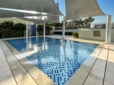 a swimming pool with an umbrella on top of a building at Classy Downtown Bliss with Dubai Mall Access in Dubai