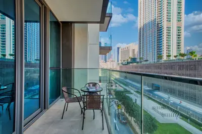 a balcony with a table and chairs and a view of a city at Classy Downtown Bliss with Dubai Mall Access in Dubai