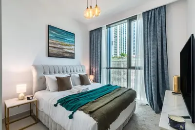 a bedroom with a large bed and a large window at Classy Downtown Bliss with Dubai Mall Access in Dubai
