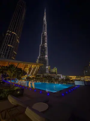 a view of the burj khalifa at night at Skyline Majesty - Luxury Living with Full Burj Khalifa & Fountain Views in Dubai