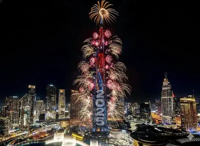 a tall tower with fireworks in front of a city at Full Burj Khalifa & Fountain View Living & Bed in Dubai
