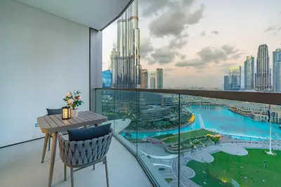 a room with a balcony with a view of a city at Iconic Views - Exclusive Burj Khalifa & Fountain Views from Every Angle in Dubai