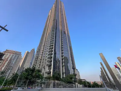 a tall building in a city with tall buildings at Iconic Views - Exclusive Burj Khalifa & Fountain Views from Every Angle in Dubai