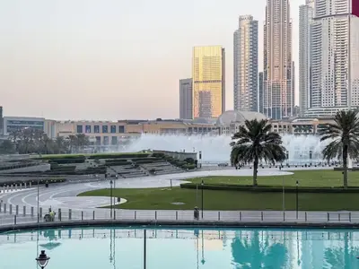a view of a city with a fountain in the background at Iconic Views - Exclusive Burj Khalifa & Fountain Views from Every Angle in Dubai
