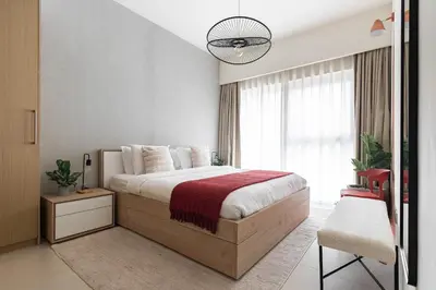 a bedroom with a bed and a large window at Arthouse Royale - 2BR with Burj Khalifa Views, Swimming Pool & Gym in Dubai