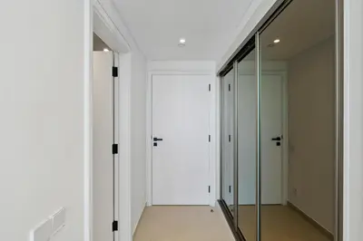 a hallway with glass doors and a mirror at Ferrari Inspired Modern 3BHK with maids room and Full Sea View in Dubai