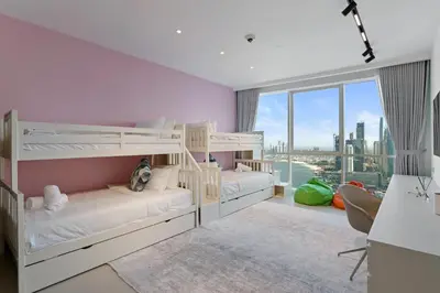 two bunk beds in a bedroom with a view of the city at Ferrari Inspired Modern 3BHK with maids room and Full Sea View in Dubai