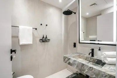 a bathroom with a sink and a mirror at Ferrari Inspired Modern 3BHK with maids room and Full Sea View in Dubai