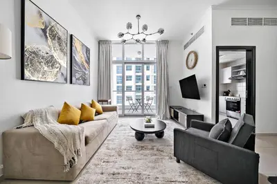 a living room with a couch and a table at Newly-furnished 1BR at DEC Tower 2 in Dubai