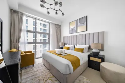a bedroom with a large bed and a large window at Newly-furnished 1BR at DEC Tower 2 in Dubai