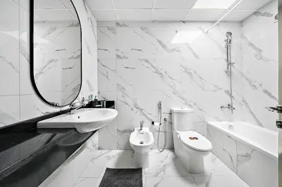 a bathroom with a sink and a toilet and a mirror at Newly-furnished 1BR at DEC Tower 2 in Dubai