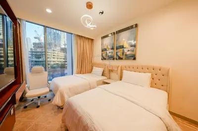 a hotel room with two beds and a window at Forte Luxe - Stylish 2BR Downtown Escape in Dubai