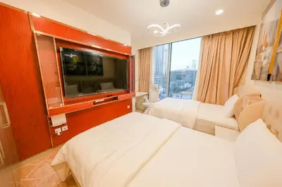 a hotel room with a bed and a flat screen tv at Forte Luxe - Stylish 2BR Downtown Escape in Dubai