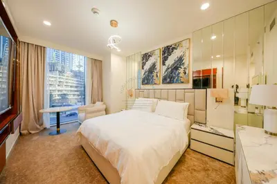a bedroom with a large white bed and a window at Forte Luxe - Stylish 2BR Downtown Escape in Dubai
