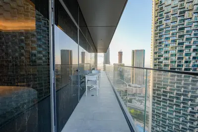 a balcony with a table and chairs on a building at 3 BHK Luxury Living at The Address Opera in Dubai