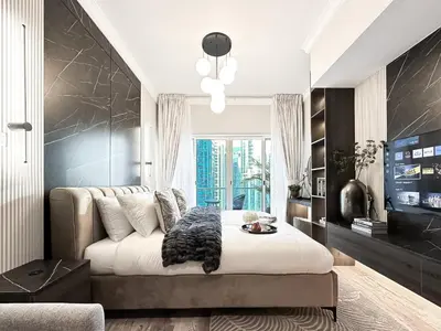 a bedroom with a large white bed in a room at Trophy- Radiant Retreat in JLT With Skyline View in Dubai