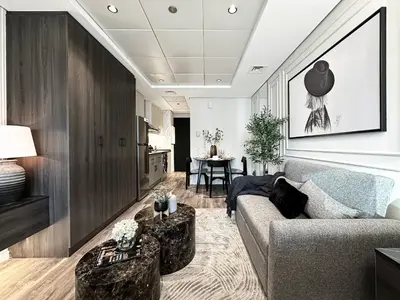 a living room with a couch and a table at Trophy- Radiant Retreat in JLT With Skyline View in Dubai