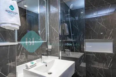 a bathroom with a sink and a mirror at Bloomfields Luxury Escape Studio In Samana Golf in Dubai
