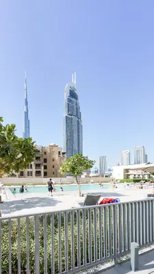 a pool in the middle of a city with tall buildings at Cozy 1-BR in the heart of Dubai with skyline views in Dubai