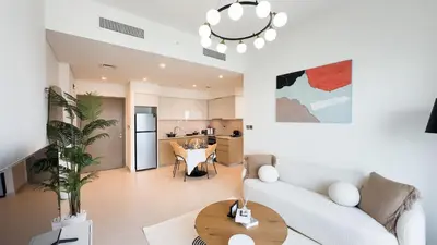 a living room with a white couch and a table at Cozy 1-BR in the heart of Dubai with skyline views in Dubai