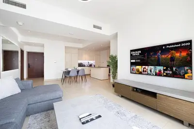 a living room with a large flat screen tv on a wall at 3BR Full Marina View for 8 Near The Metro! in Dubai