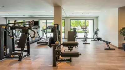 a gym with treadmills and exercise bikes in a room at Elegant 2BR in Burj Royale in Dubai