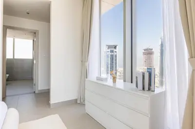 a living room with a large window with a city view at Luxury 3BR and Maid room Forte Tower 1 with Fountain View in Dubai