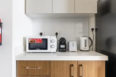 a microwave sitting on a counter in a kitchen at Luxury 3BR and Maid room Forte Tower 1 with Fountain View in Dubai