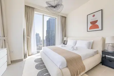 a bedroom with a large bed and a large window at Luxury 3BR and Maid room Forte Tower 1 with Fountain View in Dubai