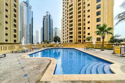 a swimming pool in a city with tall buildings at Upgraded 1B with Beach Access and Ain Dubai Views in Dubai