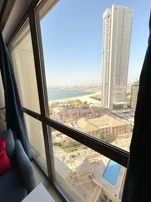a view of the ocean from a hotel room window at Breathtaking Sea and Palm View Spacious Studio with Vibrant Vibes in JBR By SWEET HOMES in Dubai