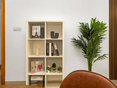 a book shelf with books and a potted plant at Spacious Home in the heart of Marina w Seaview in Dubai
