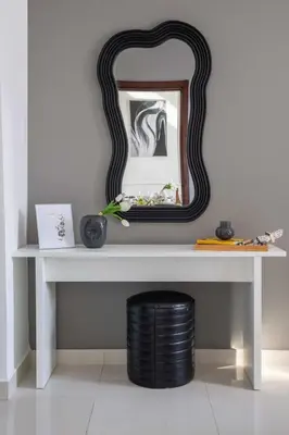 a white table with a mirror and a black stool at Frank Porter - Dezire Residences in Dubai