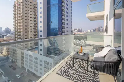 an apartment balcony with a view of a city at Frank Porter - Dezire Residences in Dubai