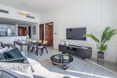a living room with a couch and a table at Frank Porter - Dezire Residences in Dubai