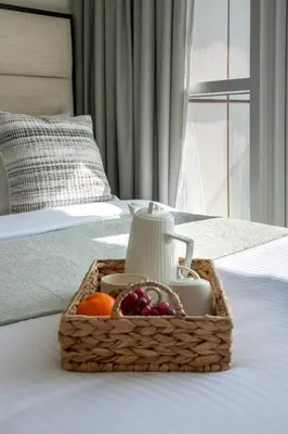 a basket of fruit sitting on top of a bed at Frank Porter - Damac Carson B in Dubai