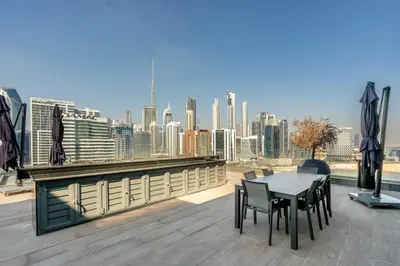 a table and chairs on a roof with a view of a city at GuestReady - Urban retreat at 15 Northside in Dubai